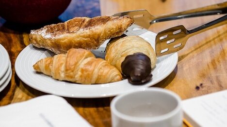 Croissants cup plates on table