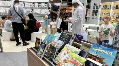 Part of German stand in Abu Dhabi 2024 with books on table