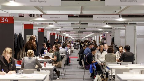 Picture of the Agency Center with people having meetings