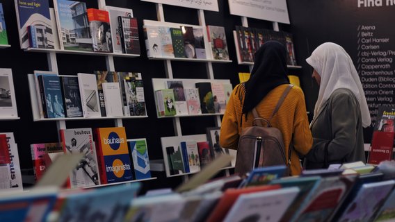 Two women at a German Collective Stand